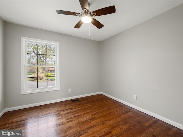 unfurnished room featuring visible vents, baseboards, ceiling fan, and wood finished floors