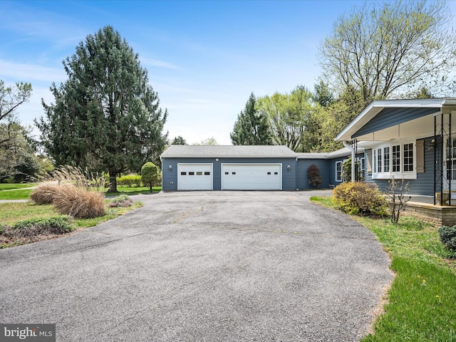 exterior space featuring a garage and aphalt driveway