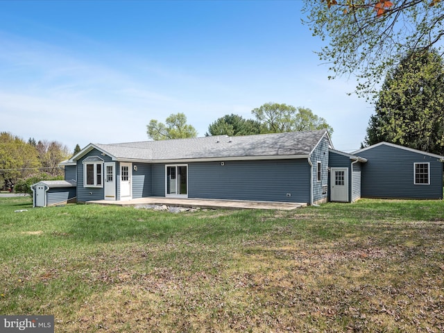 rear view of house featuring a patio and a lawn