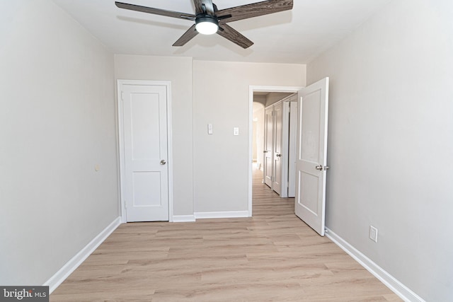 unfurnished bedroom featuring light wood-style floors, ceiling fan, and baseboards