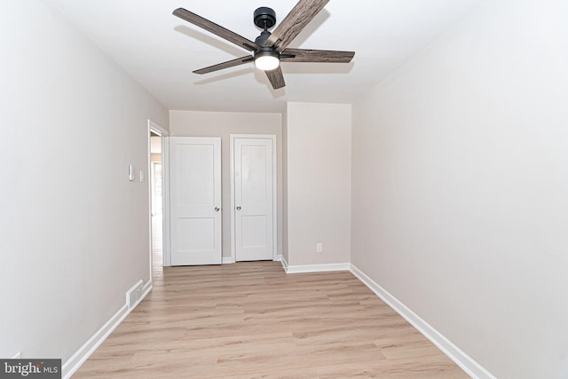 unfurnished bedroom with light wood-style floors, visible vents, baseboards, and a ceiling fan