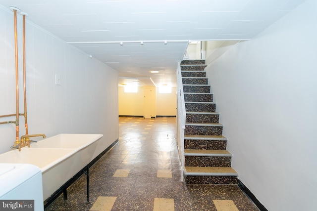 stairway with washer / dryer and baseboards