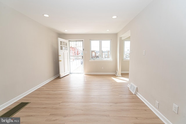 entrance foyer featuring light wood finished floors, baseboards, visible vents, and recessed lighting