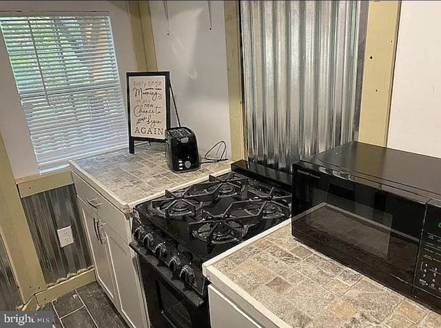 kitchen featuring black appliances and tile counters