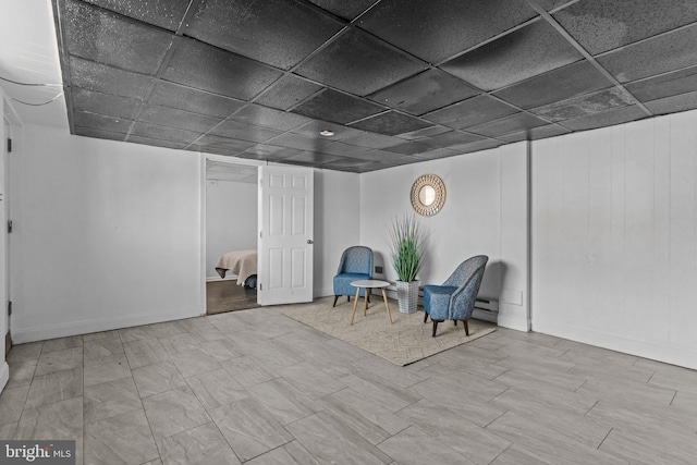 unfurnished room featuring a drop ceiling and baseboard heating