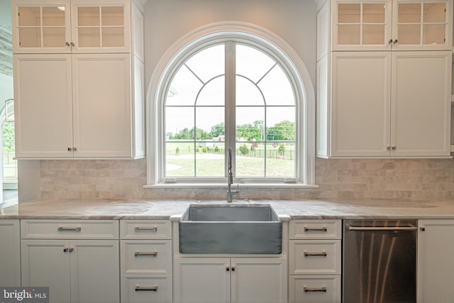 kitchen with decorative backsplash, a sink, glass insert cabinets, and white cabinets