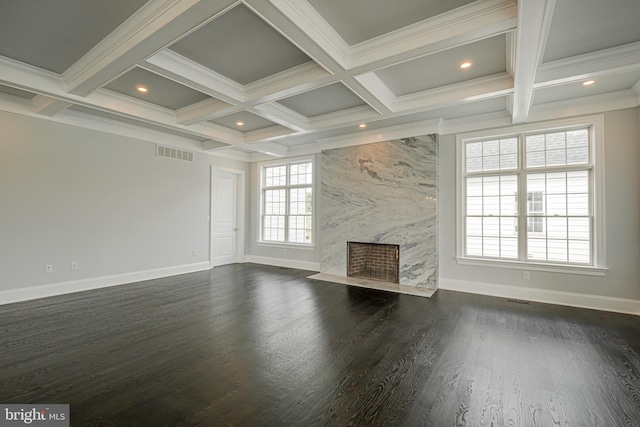 unfurnished living room featuring dark wood-style flooring, a fireplace, visible vents, baseboards, and beam ceiling