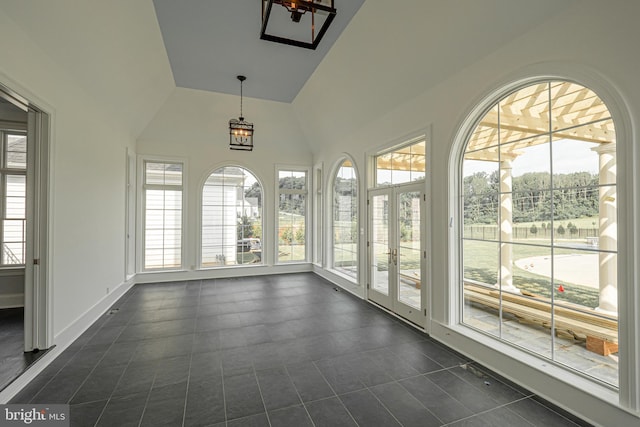 unfurnished sunroom with vaulted ceiling and a healthy amount of sunlight