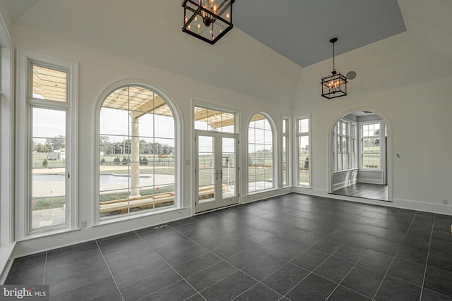 unfurnished sunroom with arched walkways