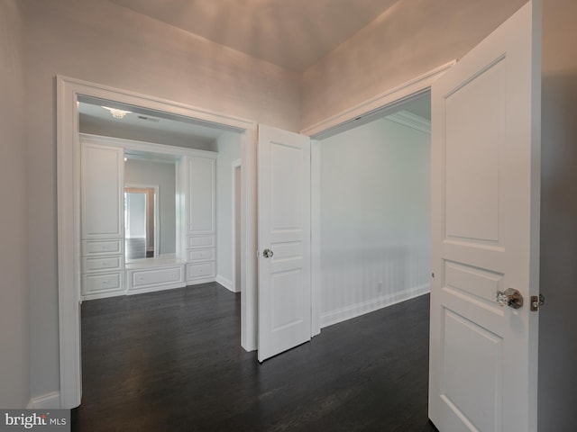 hallway featuring dark wood-style floors and baseboards