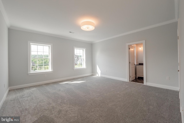 unfurnished room featuring carpet, crown molding, and baseboards