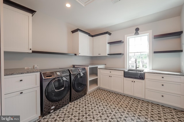 washroom featuring cabinet space, visible vents, washing machine and dryer, a sink, and recessed lighting