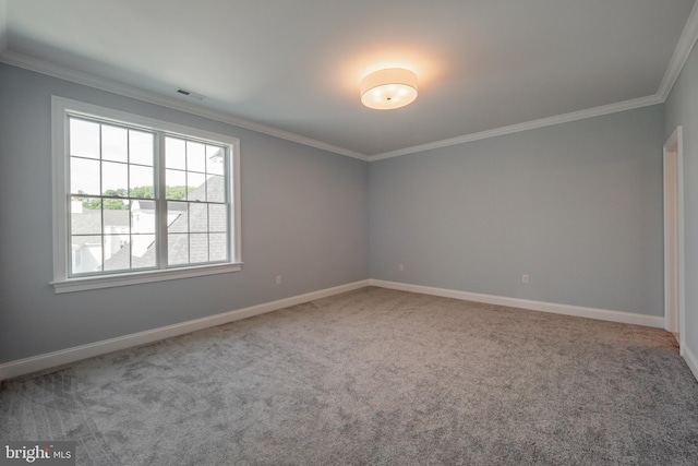 unfurnished room featuring ornamental molding, carpet, visible vents, and baseboards