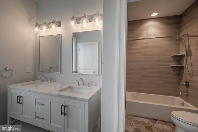 full bath with double vanity, shower / washtub combination, a sink, and toilet