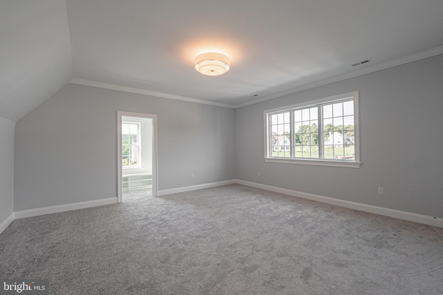 interior space featuring visible vents, baseboards, vaulted ceiling, and ornamental molding