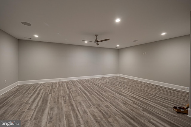 spare room with a ceiling fan, baseboards, wood finished floors, and recessed lighting