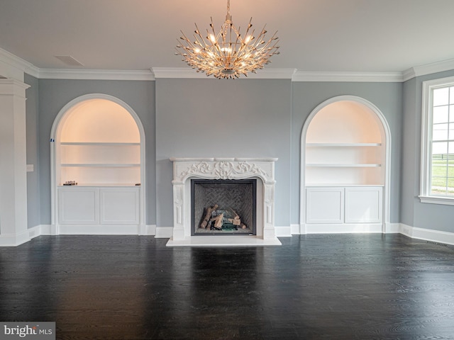 unfurnished living room featuring built in features, a high end fireplace, ornamental molding, and wood finished floors