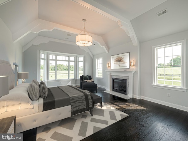 bedroom featuring lofted ceiling with beams, a fireplace with flush hearth, visible vents, baseboards, and dark wood finished floors