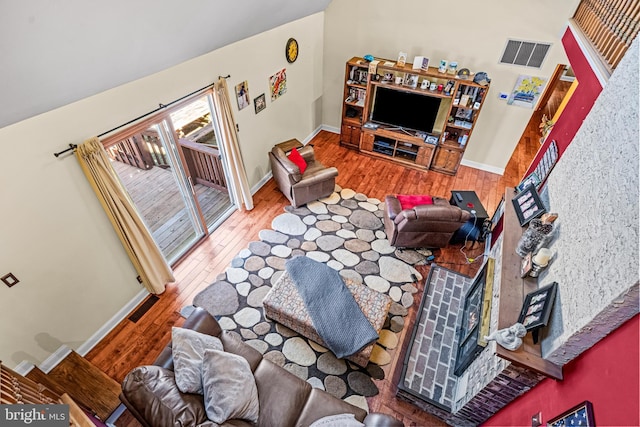 living room with visible vents, baseboards, and wood finished floors