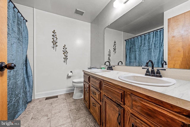 full bath with toilet, visible vents, and a sink