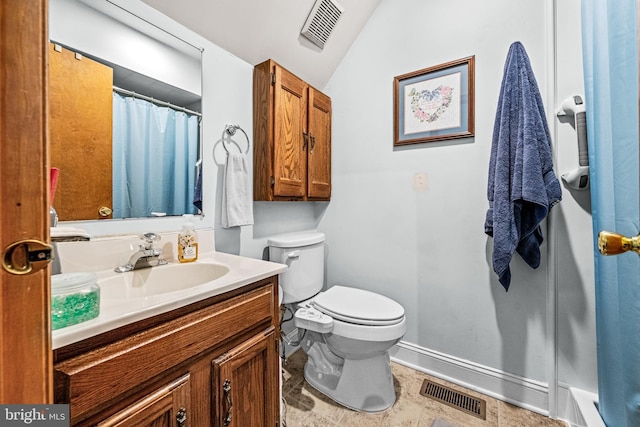 bathroom with vanity, vaulted ceiling, toilet, and visible vents