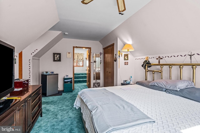 bedroom with vaulted ceiling, carpet flooring, and a closet