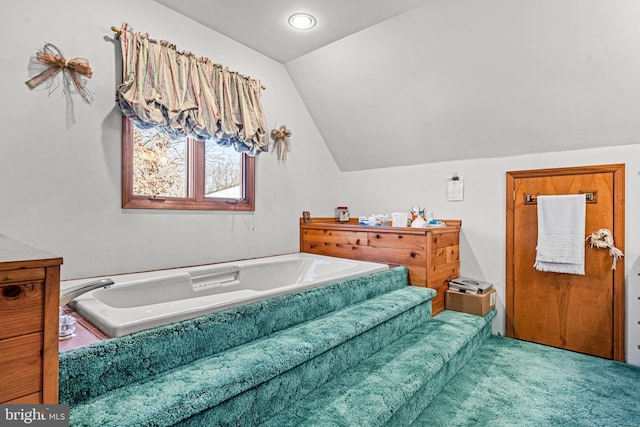 full bathroom with lofted ceiling and a bath