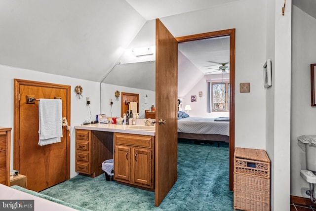 ensuite bathroom featuring a ceiling fan, lofted ceiling, vanity, and ensuite bathroom