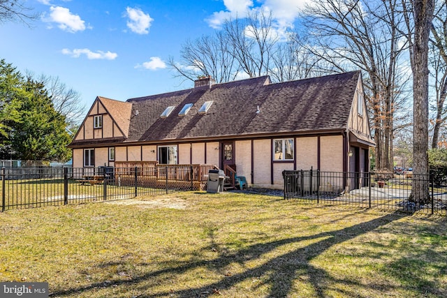 back of property with stucco siding, a chimney, a yard, and fence