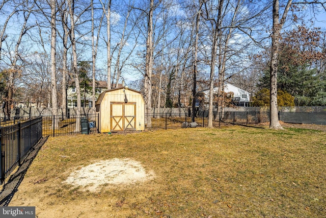 view of yard featuring an outbuilding, a storage unit, and fence