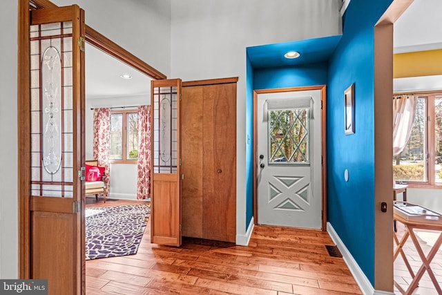 foyer entrance with recessed lighting, visible vents, baseboards, and light wood finished floors