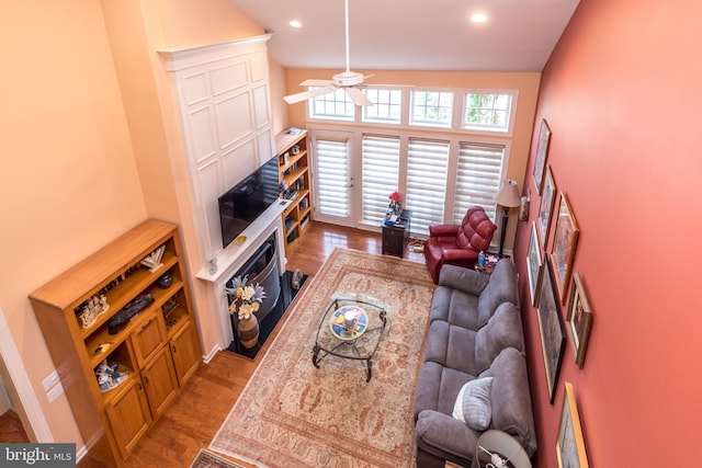 living room with wood finished floors, a ceiling fan, and recessed lighting