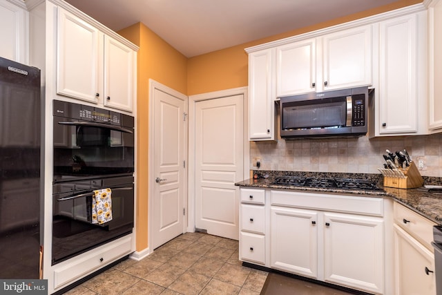 kitchen with decorative backsplash, dark stone counters, white cabinetry, and black appliances