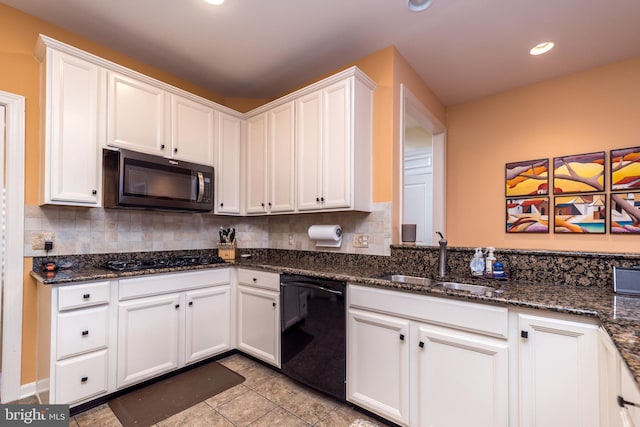 kitchen with black appliances, backsplash, a sink, and white cabinets