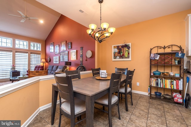 dining room featuring baseboards, visible vents, tile patterned flooring, vaulted ceiling, and ceiling fan with notable chandelier