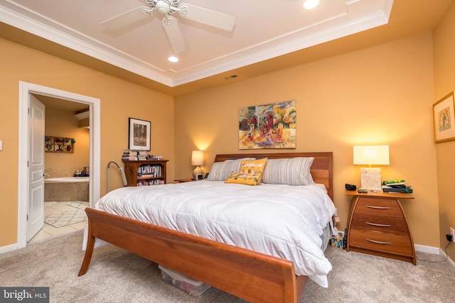 carpeted bedroom featuring baseboards, a raised ceiling, ensuite bath, crown molding, and recessed lighting