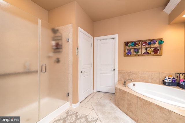 bathroom with a stall shower, tile patterned floors, and a bath