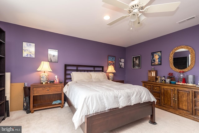 bedroom with visible vents, ceiling fan, and light carpet