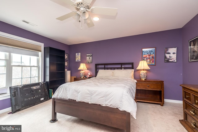 carpeted bedroom featuring baseboards, visible vents, and ceiling fan