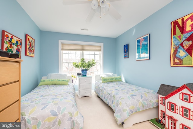 carpeted bedroom featuring ceiling fan and visible vents