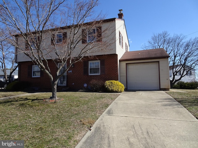 colonial home featuring a front yard, a chimney, concrete driveway, a garage, and brick siding