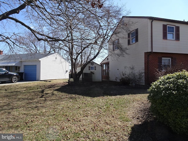 view of home's exterior with a yard, brick siding, and an attached garage