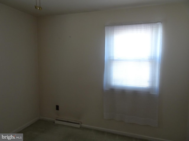 carpeted empty room featuring baseboards and baseboard heating