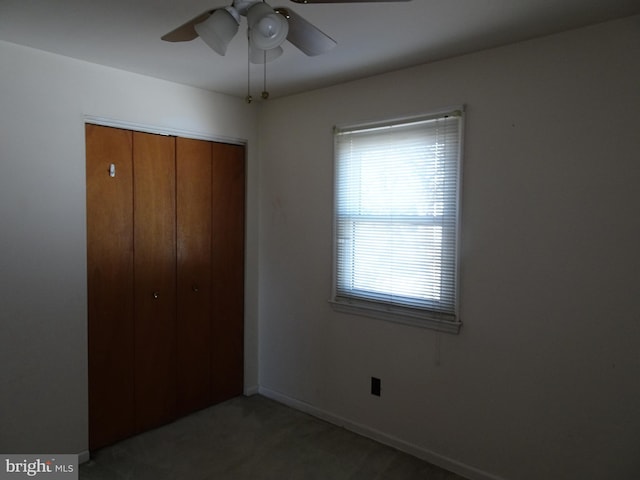 unfurnished bedroom with a closet, ceiling fan, and baseboards