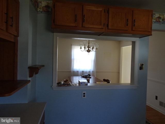 kitchen with visible vents and brown cabinets