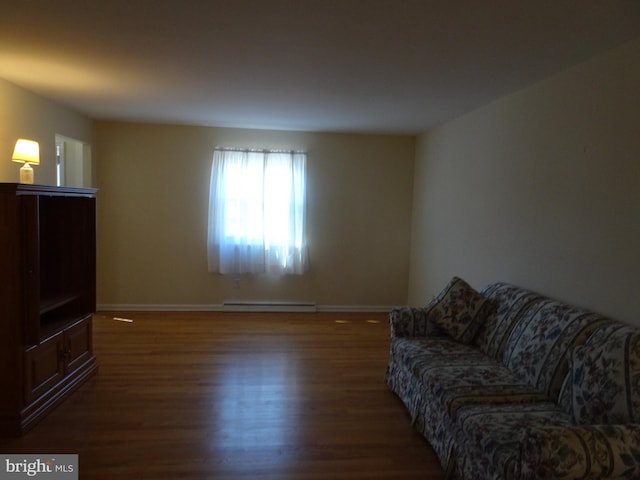 living area featuring wood finished floors, baseboards, and baseboard heating