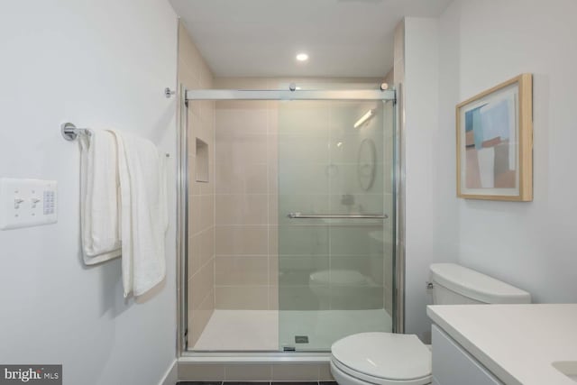 full bath featuring a stall shower, vanity, toilet, and recessed lighting