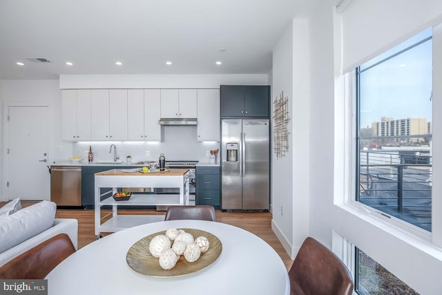 dining space with recessed lighting, visible vents, baseboards, and wood finished floors