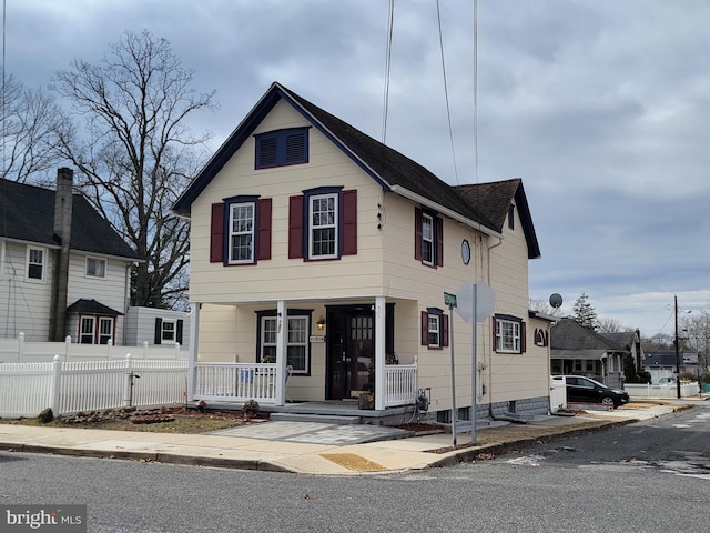 view of front facade with a porch and fence