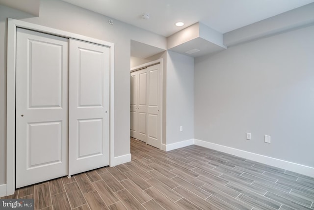 below grade area with baseboards, recessed lighting, and wood tiled floor